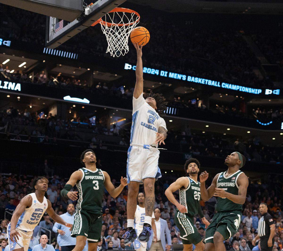 North Carolina’s Elliot Cadeau (2) breaks to the basket through the Michigan State defense during the second half on Saturday, March 23, 2024, in the second round of the NCAA Tournament at Spectrum Center in Charlotte, N.C. Cadeau scored six points in the victory.