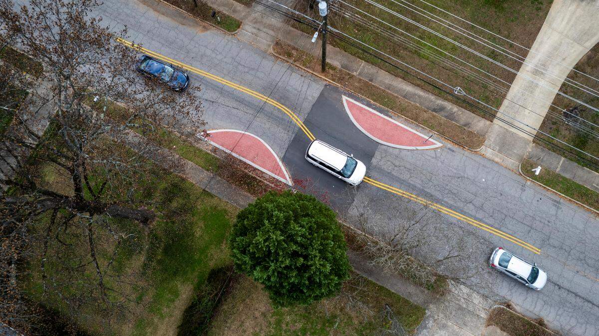 Drivers navigate through traffic-calming measures along a 1.2-mile stretch of Brentwood Road, between Capital Boulevard and New Hope Church Road in North Raleigh, on Dec 12, 2022. Among them are nearly a dozen of these “chicanes” or small islands built in pairs to create an S-curve.
