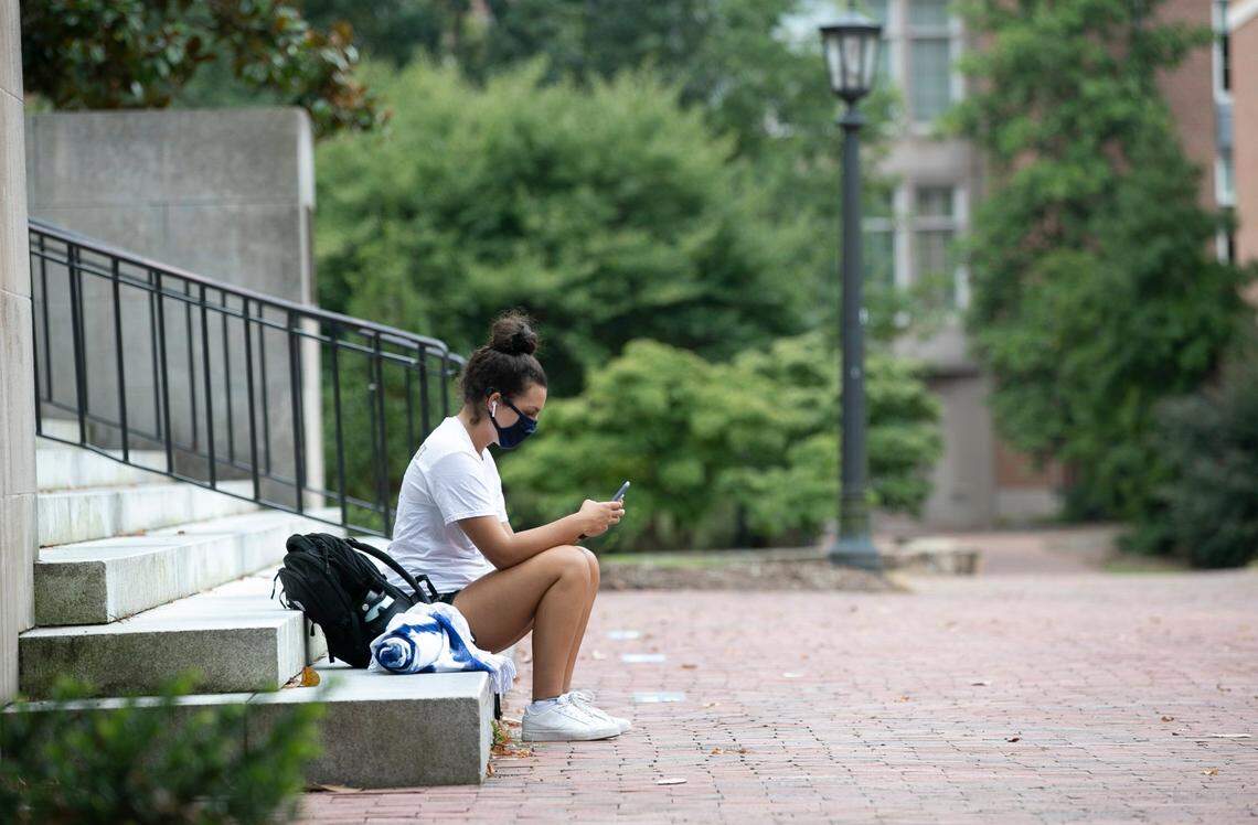 Isabella Parsons, a sophomore political science major from Raleigh, sits alone on the steps of Wilson Library on the University of North Carolina campus on Thursday, August 20, 2020 in Chapel Hill, N.C. Parsons is moving out of her room at Carmichael Residence Hall on Sunday after all classes were moved online due to the COVID-19 virus outbreak on campus.