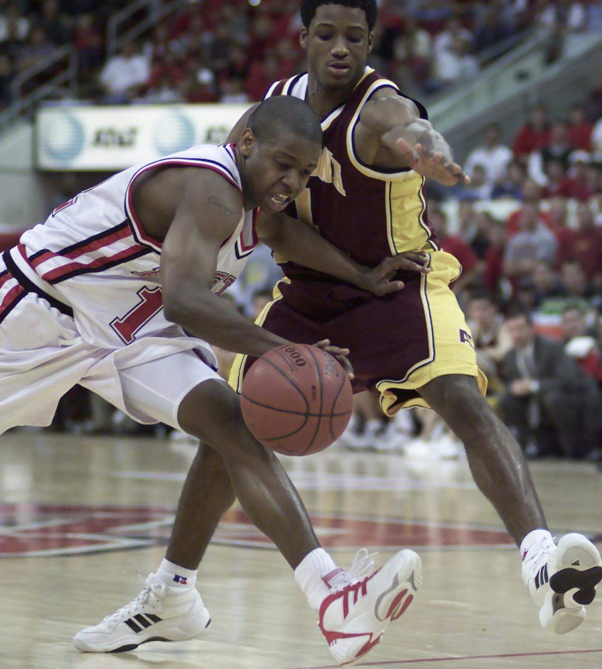 N.C. StateÕs Justin Gainey (12) works his way around Arizona's Alton Mason (1) during the second half action against Arizona State in the NIT Tournament in 2000.