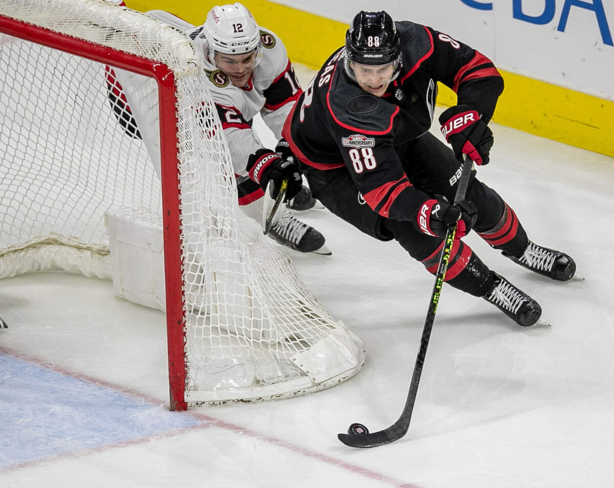 Ottawa’s Austin Watson (16) works to stop Carolina’s Hurricanes’ Martin Necas (88) as he moves the puck behind the Ottawa goal in overtime on Tuesday, April 4, 2023 at PNC Arena in Raleigh, N.C.