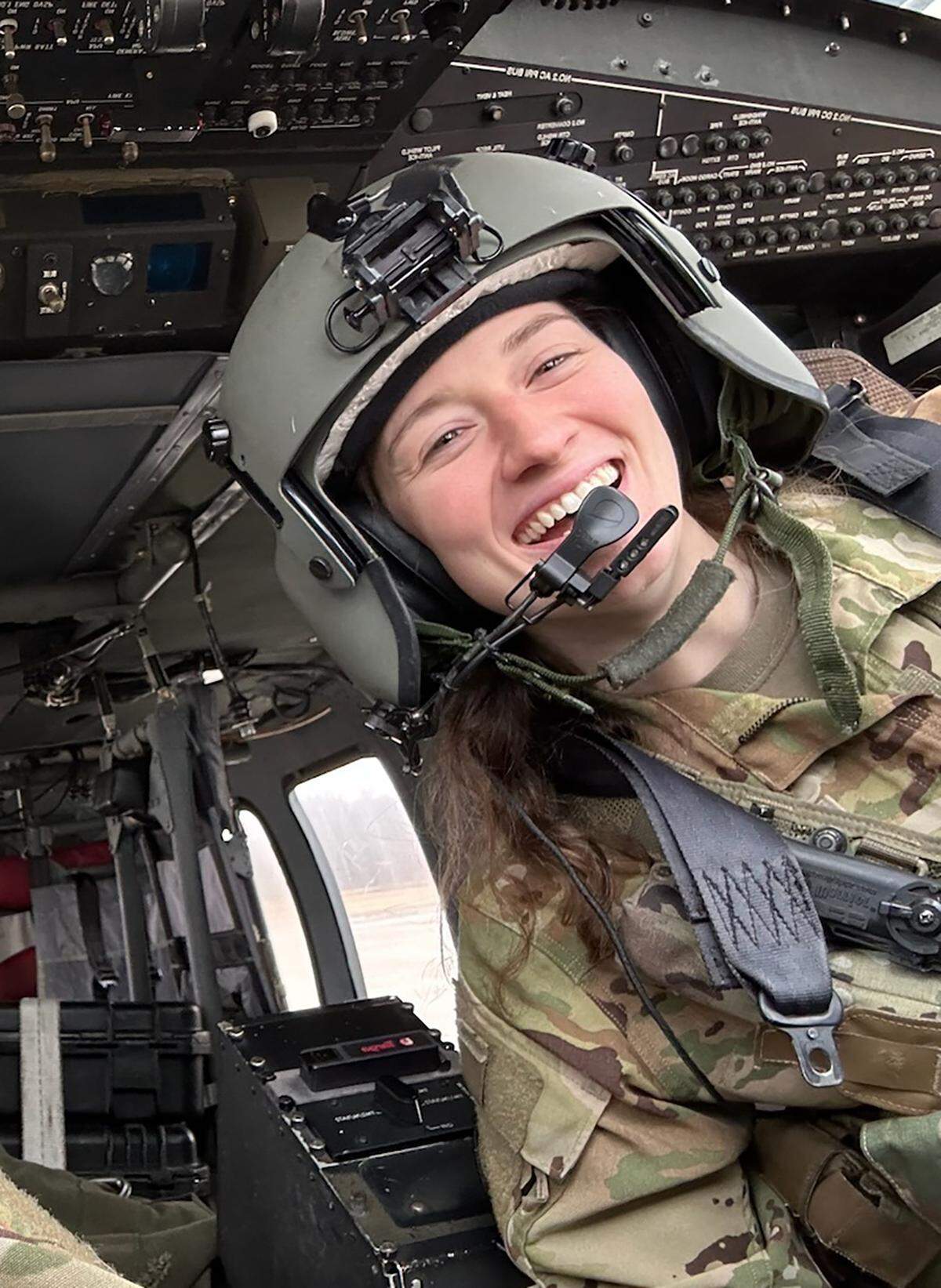 Capt. Rebecca Lobach (right) in the cockpit of a UH-60 Black Hawk helicopter, Feb. 28, 2024. 
