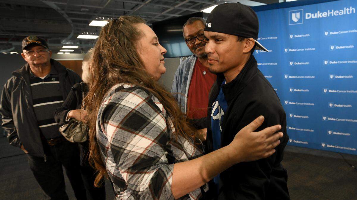 Johnathan Nauta (right) gets a hug from Sherry Scales (left) as they attend a press conference at Duke Medical Center Thursday, Nov. 15, 2018 in Durham, N.C. Nauta received the first abdominal wall transplant in the Carolinas thanks to an organ donor and a medical team at Duke University Hospital.Nauta, 37, of Fayetteville, received a simultaneous abdominal wall and bowel transplant on Oct. 12 at Duke that lasted 14 hours and involved a team of 25 doctors, nurses and staff.The organ donor was Marcus Scales, 13, a middle school student in Rockingham County who died on Oct. 10.