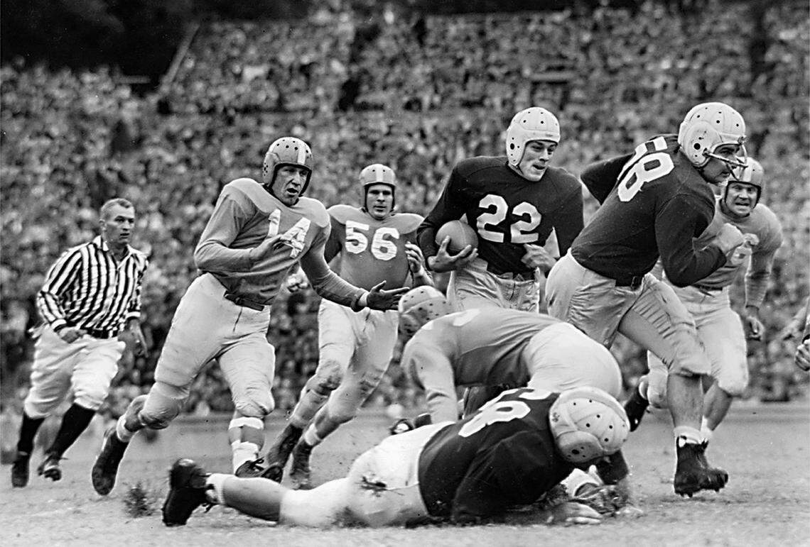 Charlie Justice (22) follows the block of Carolina tackle Heywood Fowle (58) for a good gain against Tennessee in Kenan Stadium in 1948.
