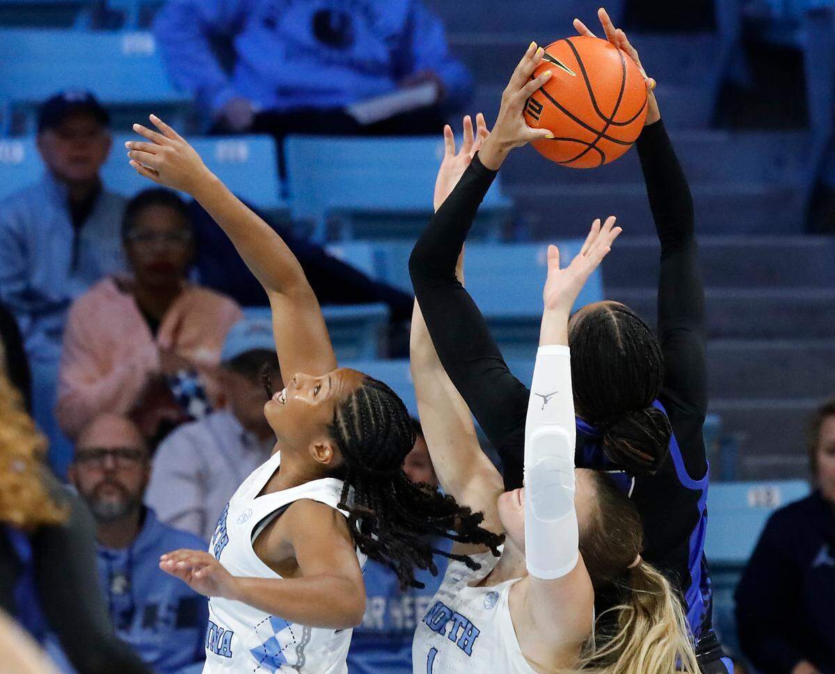 North Carolina’s Indya Nivar and Alyssa Ustby battle for a rebound with Kentucky’s Teonni Key during the first half of the Tar Heels’ 72-53 win on Thursday, Dec. 5, 2024, at Carmichael Arena in Chapel Hill, N.C.