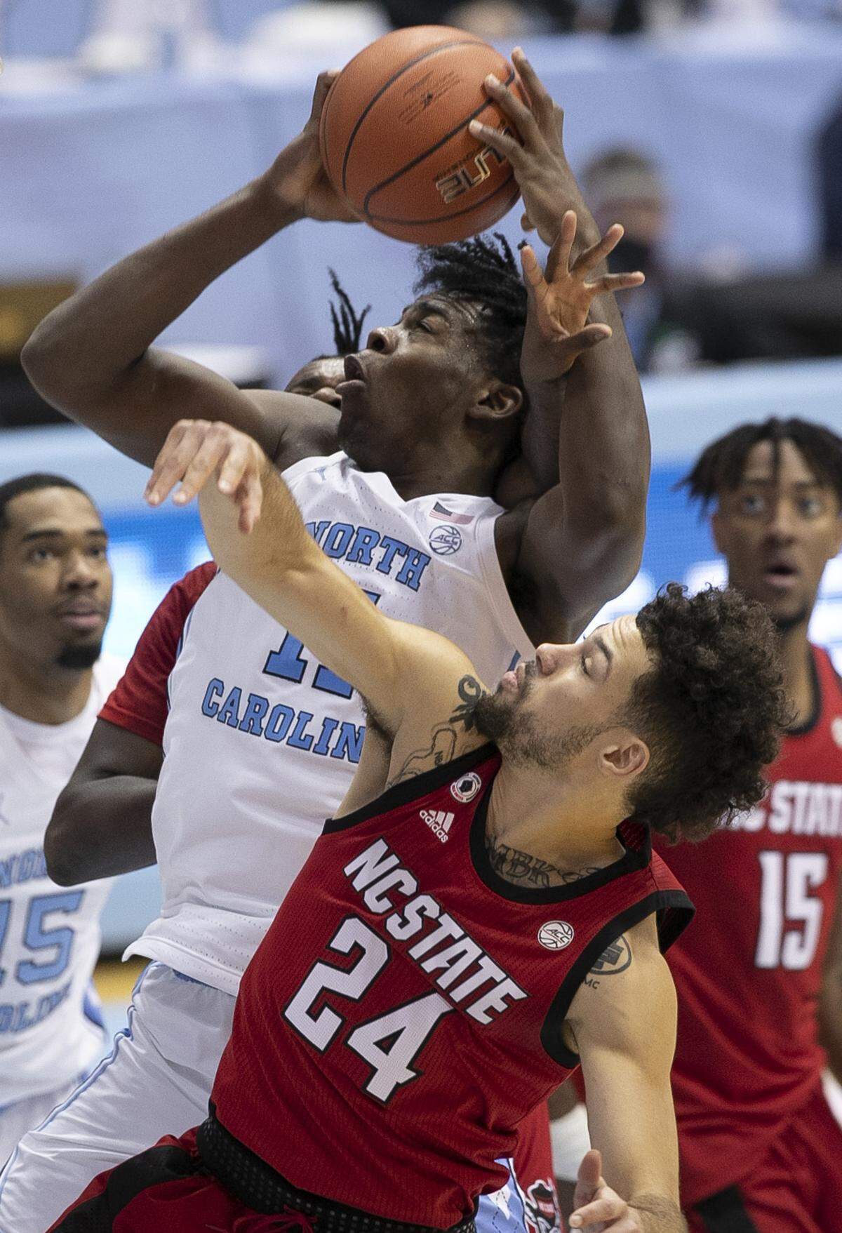 North Carolina’s DayÕRon Sharpe (11) muscles his way to the basket for two of his 16 points in the second half against NC State’s Devon Daniels (24) on Saturday, January 23, 2021 at the Smith Center in Chapel Hill, NC.