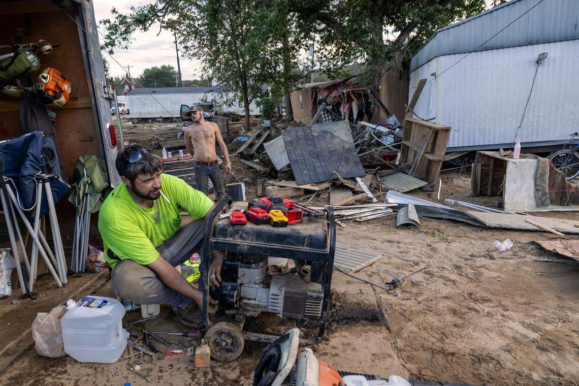 Rodney Stevens Jr. tries to salvage a generator next to his damage home on Wednesday, October 2, 2024 in Old Fort, N.C. Stevens Jr was trying to salvage personal items after flood waters from Hurricane Helene flooded Mill Creek and his neighborhood in the center of town.