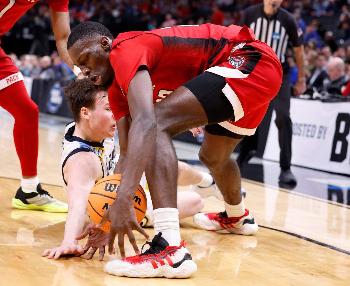 N.C. State’s Mohamed Diarra (23) steals the ball from Marquette’s Tyler Kolek (11) during the first half of N.C. State’s game against Marquette in their NCAA Tournament Sweet 16 game at the American Airlines Center in Dallas, Texas, Friday, March 29, 2024.