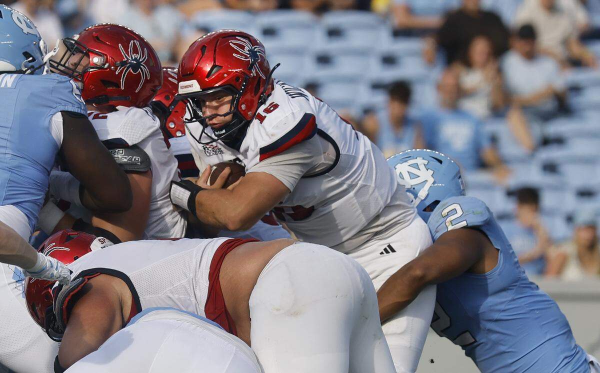 On fourth and goal, North Carolina linebacker Andrew Simpson (2) gets his arms around Richmond quarterback Kyle Wickersham (16) to stop him during the second half of UNC’s 41-6 victory over Richmond at Kenan Stadium in Chapel Hill, N.C., Saturday, Sept. 13, 2025.