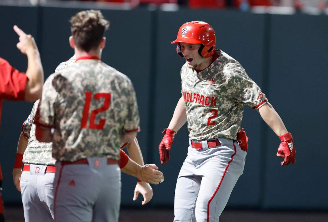 N.C. State’s Noah Soles (2) celebrates with teammates after scoring on a solo home run in ninth inning during N.C. State’s 5-3 victory over James Madison in the NCAA Raleigh Regional final at Doak Field Sunday, June 2, 2024.