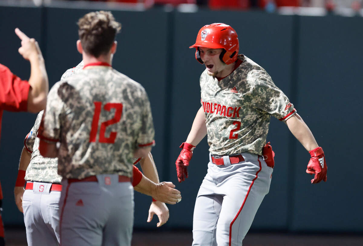 N.C. State’s Noah Soles (2) celebrates with teammates after scoring on a solo home run in ninth inning during N.C. State’s 5-3 victory over James Madison in the NCAA Raleigh Regional final at Doak Field Sunday, June 2, 2024.
