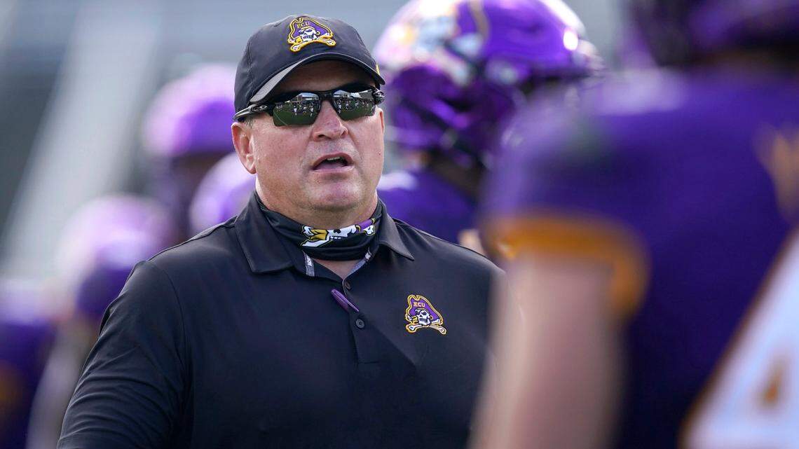 East Carolina head coach Mike Houston talks with his players during a game against Central Florida in Greenville, N.C., Saturday, Sept. 26, 2020.