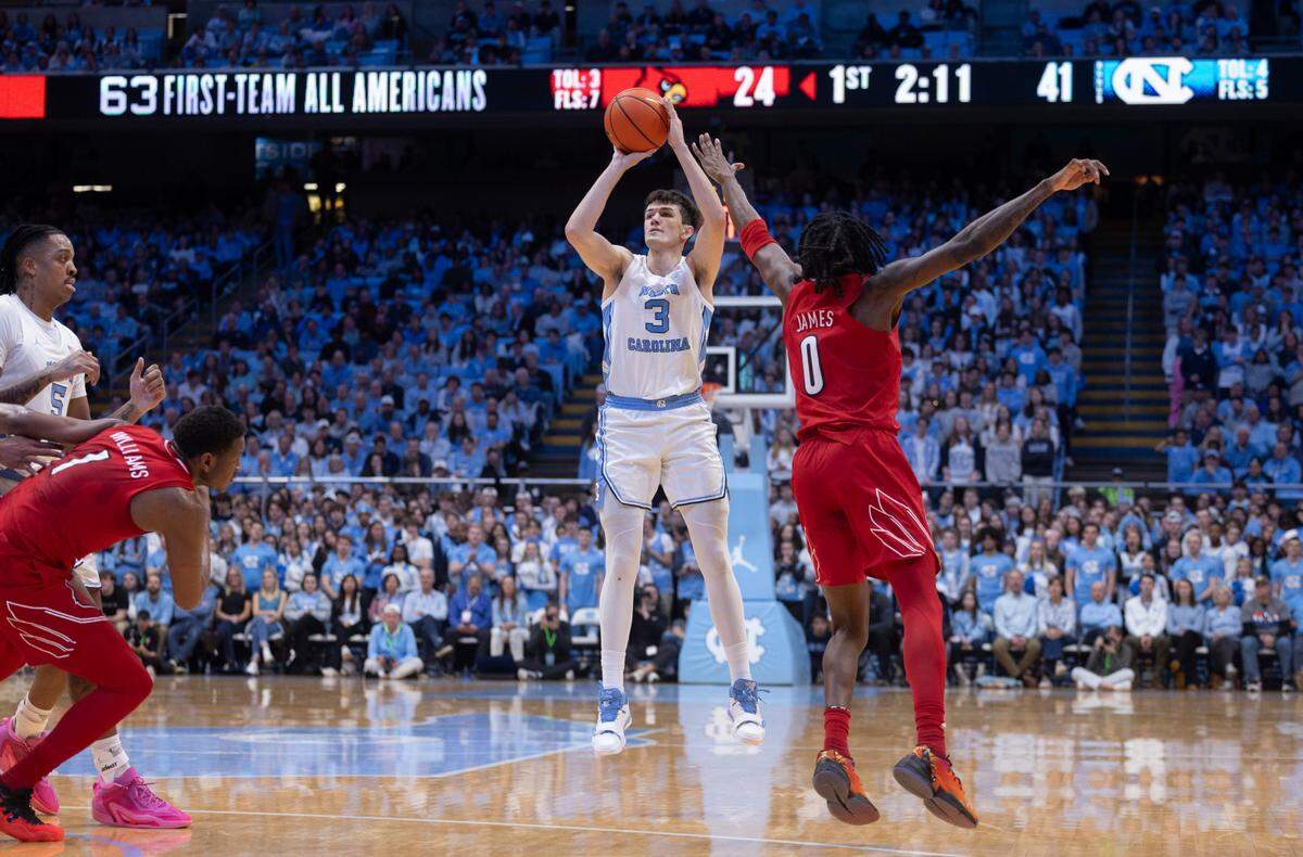 North Carolina’s Cormac Ryan (3) launches a three-point shot in the first half against Louisville’s Mike James (0) on Wednesday, January 17, 2024 at the Smith Center in Chapel Hill, N.C.