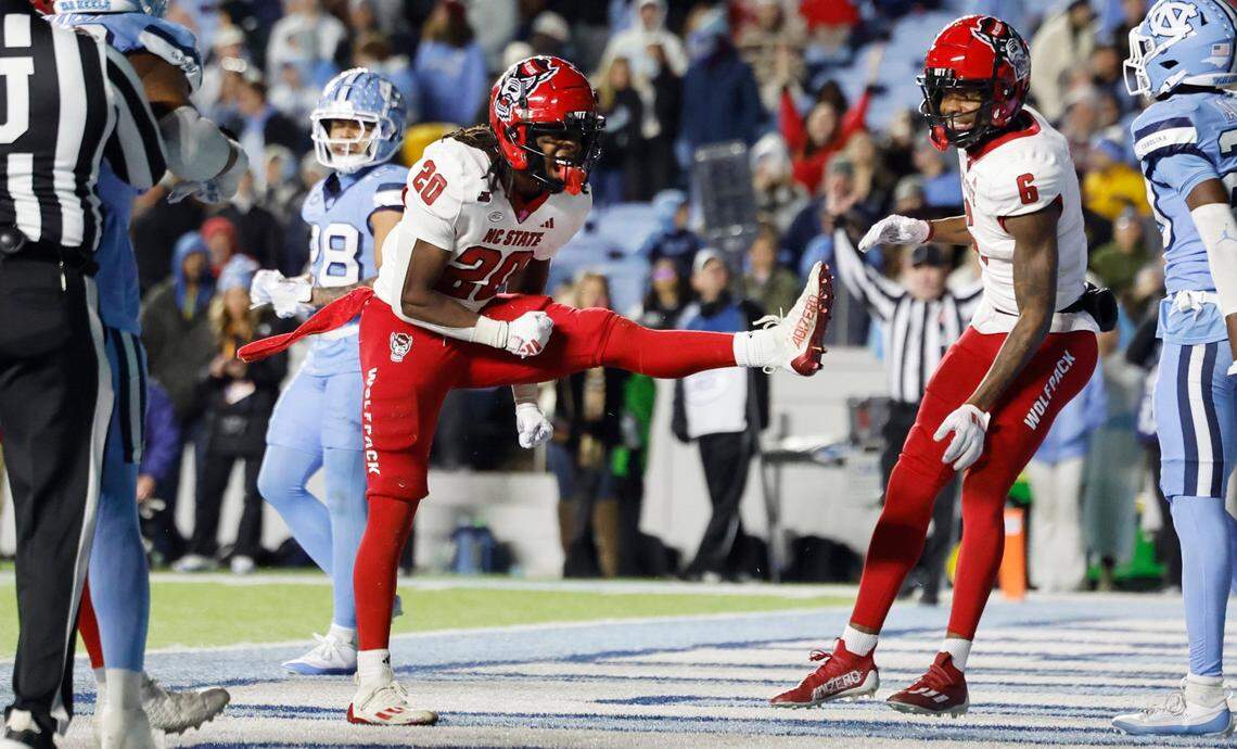 N.C. State running back Hollywood Smothers (20) celebrates scoring on a two-yard touchdown run with 25 seconds left in the game during the Wolfpack’s 35-30 victory over UNC at Kenan Stadium in Chapel Hill, N.C., Saturday, Nov. 30, 2024.