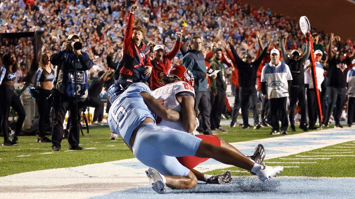 N.C. State wide receiver Devin Carter (88) makes the 26-yard touchdown reception as North Carolina defensive back Lejond Cavazos (6) defends during the second half of N.C. State’s 30-27 overtime victory over UNC at Kenan Stadium in Chapel Hill, N.C., Friday, Nov. 25, 2022.