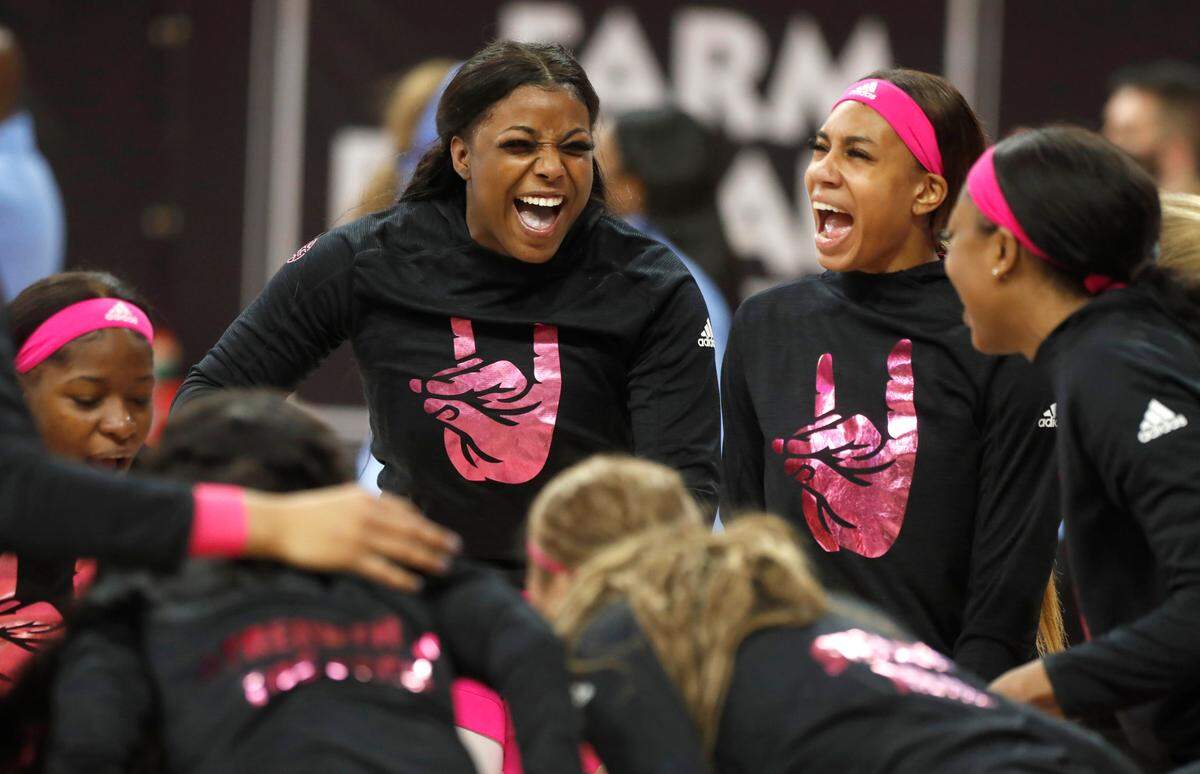 N.C. State’s Jada Rice, left, and Jakia Brown-Turner, and teammates huddle together before N.C. State’s game against UNC in the annual Play4Kay game at Reynolds Coliseum in Raleigh, N.C., Sunday, February 21, 2021.