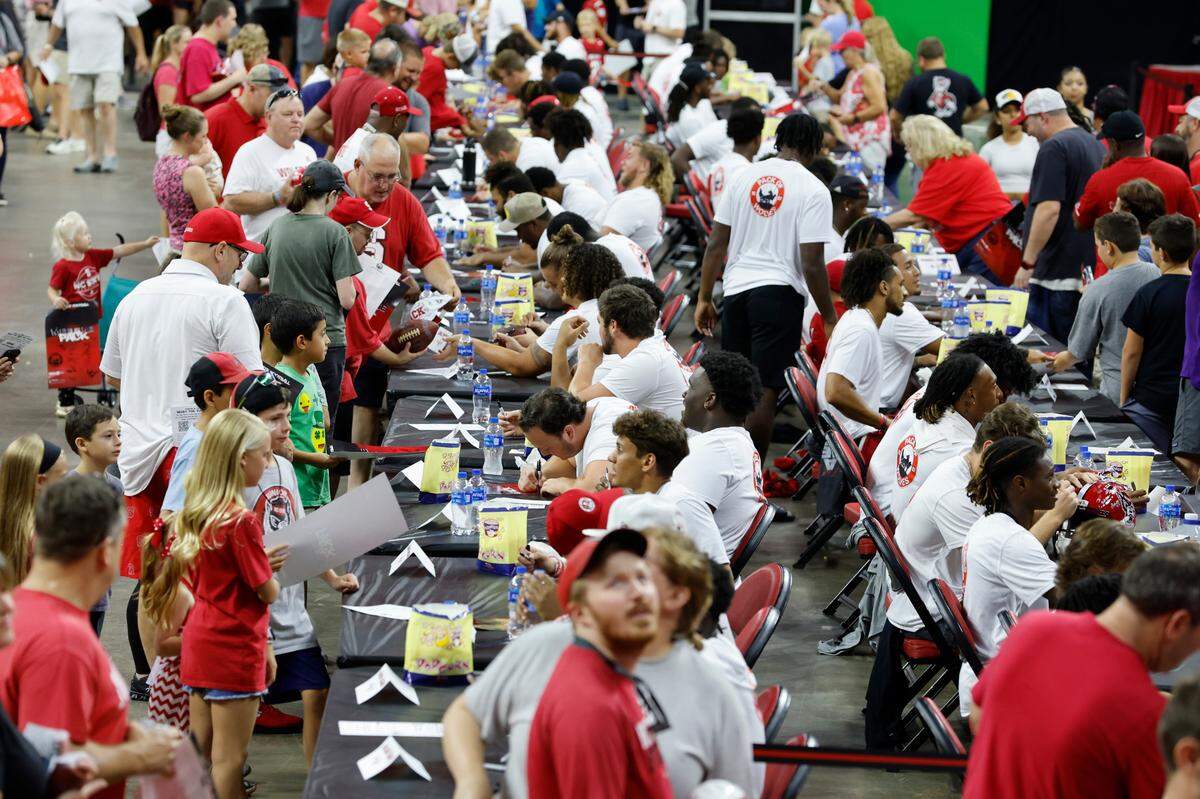 Fans line up to talk with and get autographs from N.C. State football players during the Pack of Wolves NIL Collective’s Meet the Pack at PNC Arena in Raleigh, N.C., Saturday, August 13, 2022.