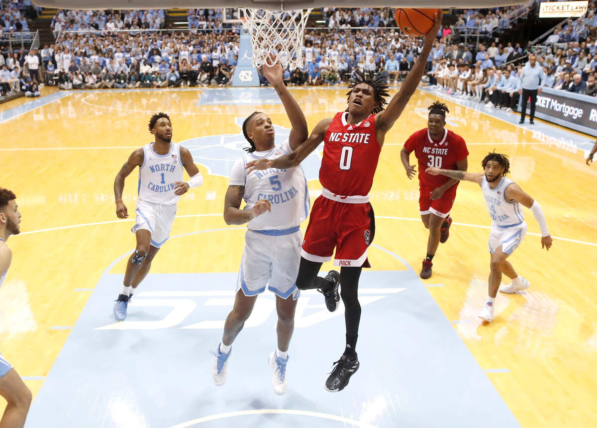N.C. State’s Terquavion Smith (0) shoots as North Carolina’s Armando Bacot (5) defends during UNC’s 80-69 victory over N.C. State at the Smith Center in Chapel Hill, N.C., Saturday, Jan. 21, 2023.