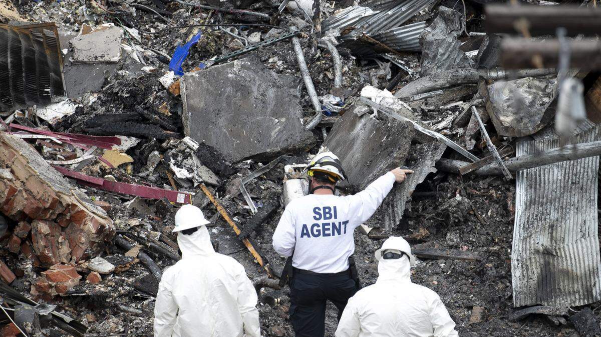 Members of the SBI and other investigators comb through the rubble of the Kaffeinate Coffee shop in downtown Durham, N.C. on April 12, 2019 looking for clues as they investigate the gas explosion that claimed the life of Kong Lee and injured 25 others.