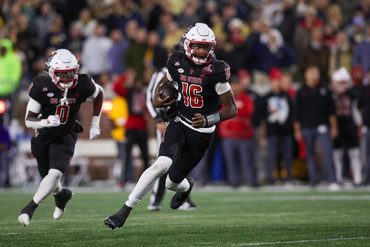 North Carolina State Wolfpack quarterback CJ Bailey (16) runs the ball for a touchdown against the Georgia Tech Yellow Jackets in the first quarter at Bobby Dodd Stadium at Hyundai Field.