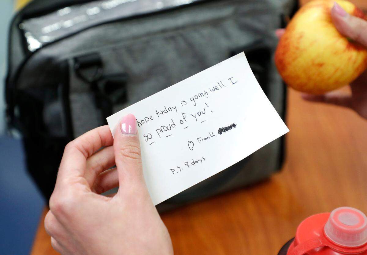 Erica South reads a note from her soon to be husband, Frank, that was placed in her lunch bag while wokring at UNC REX Hospital in Raleigh, N.C., Friday, October 1, 2021.