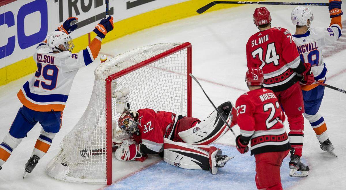 New York Islanders’ Brock Nelson (29) reacts after a goal by teammate Kyle Palmeri (21) on Carolina Hurricanes’ goalie Antii Raanta (32) in the second period during game two of their Stanley Cup series on Wednesday, April 19, 2023 at PNC Arena in Raleigh, N.C.
