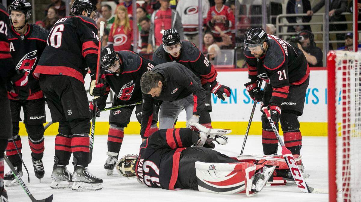 Teammates surround Carolina Hurricanes goalie Antii Raanta (32) after the went down with an injury in the second period agains the New York Rangers on Monday, May 30, 2022 during game seven of the Stanley Cup second round at PNC Arena in Raleigh, N.C.