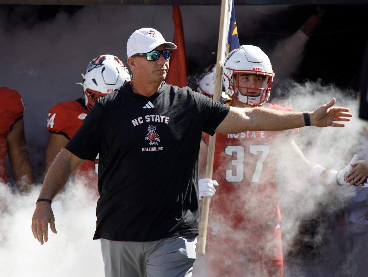 N.C. State head coach Dave Doeren acknowledges the fans as he walks onto the field prior to the Wolfpack’s game against Campbell on Saturday, Oct. 4, 2025, at Carter-Finley Stadium in Raleigh, N.C.