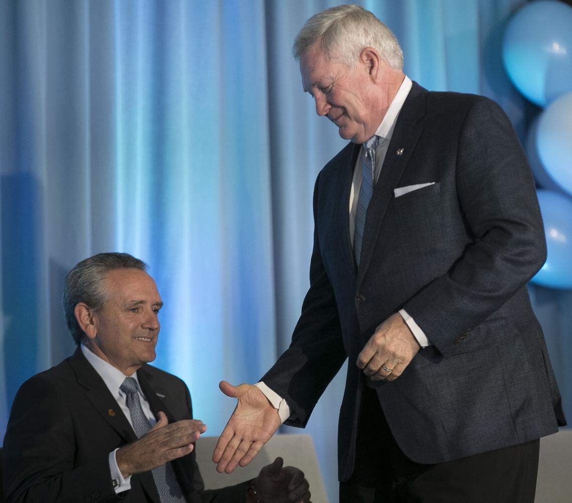 Mack Brown shakes hands with athletic director Bubba Cunningham as he is introduced as the new football coach at North Carolina on Tuesday, November 27, 2018 at Kenan Stadium in Chapel Hill, N.C. 