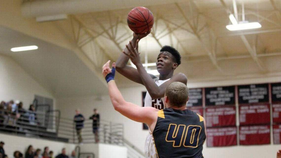 South Central's Day'ron Sharpe, right, shoots over D.H. Conley's Damian Tetterton on Feb. 9, 2017.