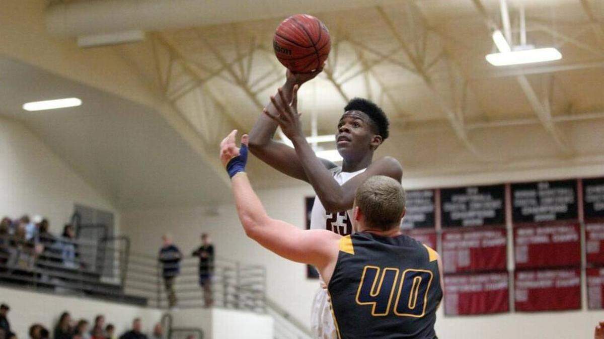 South Central's Day'ron Sharpe, right, shoots over D.H. Conley's Damian Tetterton on Feb. 9, 2017.