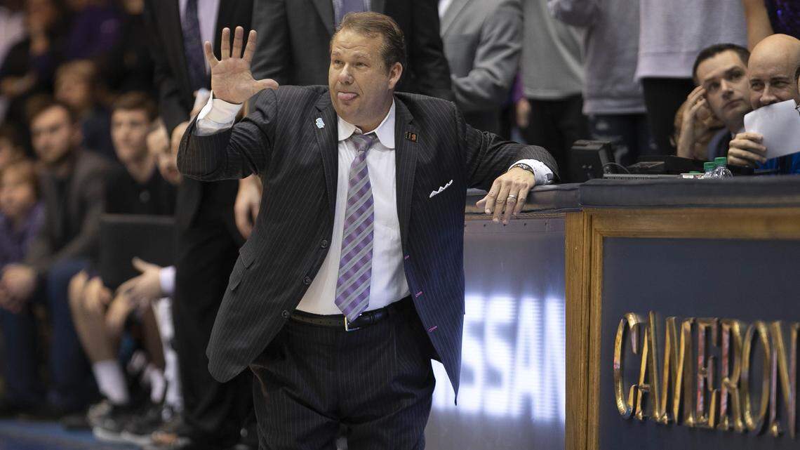 Stephen F. Austin coach Kyle Keller directs his team on defense from his knees during the second half against Duke on Tuesday, November 26, 2019 at Cameron Indoor Stadium in Durham, N.C.