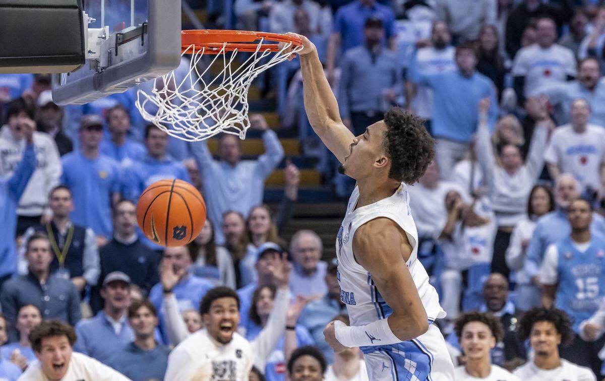North Carolina guard Seth Trimble (7) soars to the rim for a break away dunk in the second half against Louisville on Monday, February 23, 2026 at the Smith Center in Chapel Hill, N.C. Trimble led all scores with 30 points, a career high, in the Tar Heels’ 77-74 victory.