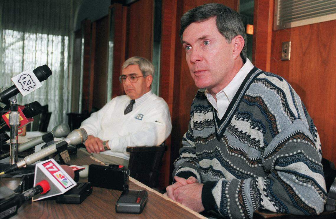 Mack Brown ponders the answer to a question as he announced his resignation as coach of the UNC football team in 1997. At left is former UNC athletic director Dick Baddour.