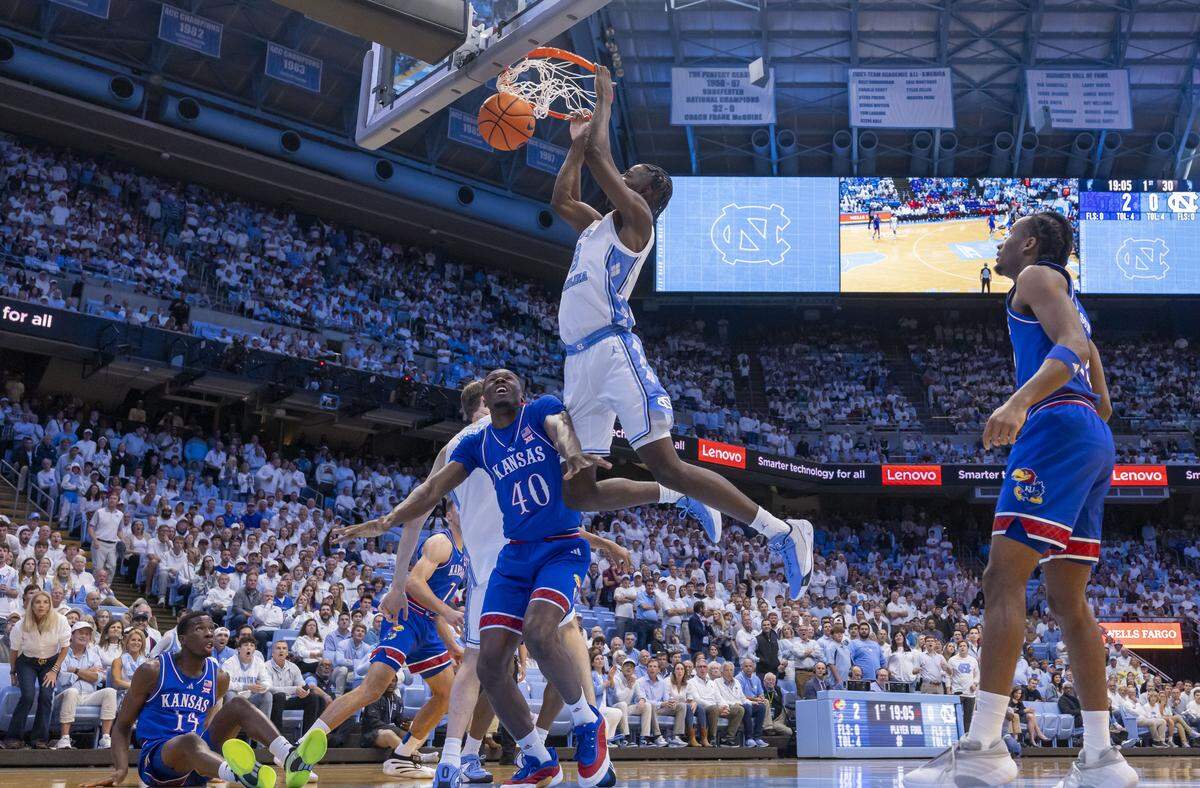 North Carolina forward Caleb Wilson (8) dunks over Kansas forward Flory Bidunga (40) in the first half on Friday, November 7, 2025 at the Smith Center in Chapel Hill, N.C.