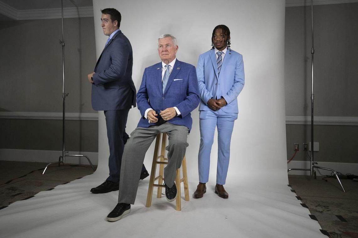 North Carolina coach Mack Brown along with offensive tackle Charlie Heck, left and safety Myles Dorn pose during a photo shoot for the ACC Social Media group on Thursday morning July 18, 2019 during the ACC Kickoff at the Westin in Charlotte, N.C.