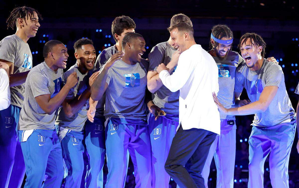 Duke head coach Jon Scheyer laughs with the players after dancing after being introduced during Duke’s Countdown to Craziness at Cameron Indoor Stadium in Durham, N.C., Friday, Oct. 21, 2022.