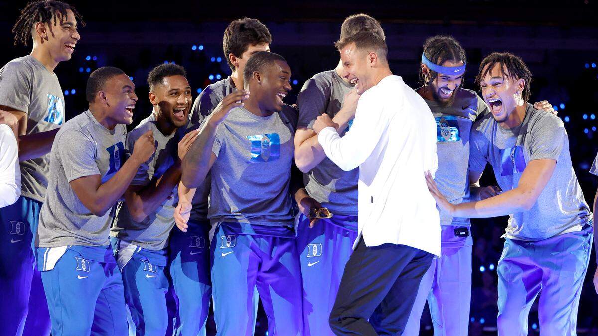 Duke head coach Jon Scheyer laughs with the players after dancing after being introduced during Duke’s Countdown to Craziness at Cameron Indoor Stadium in Durham, N.C., Friday, Oct. 21, 2022.
