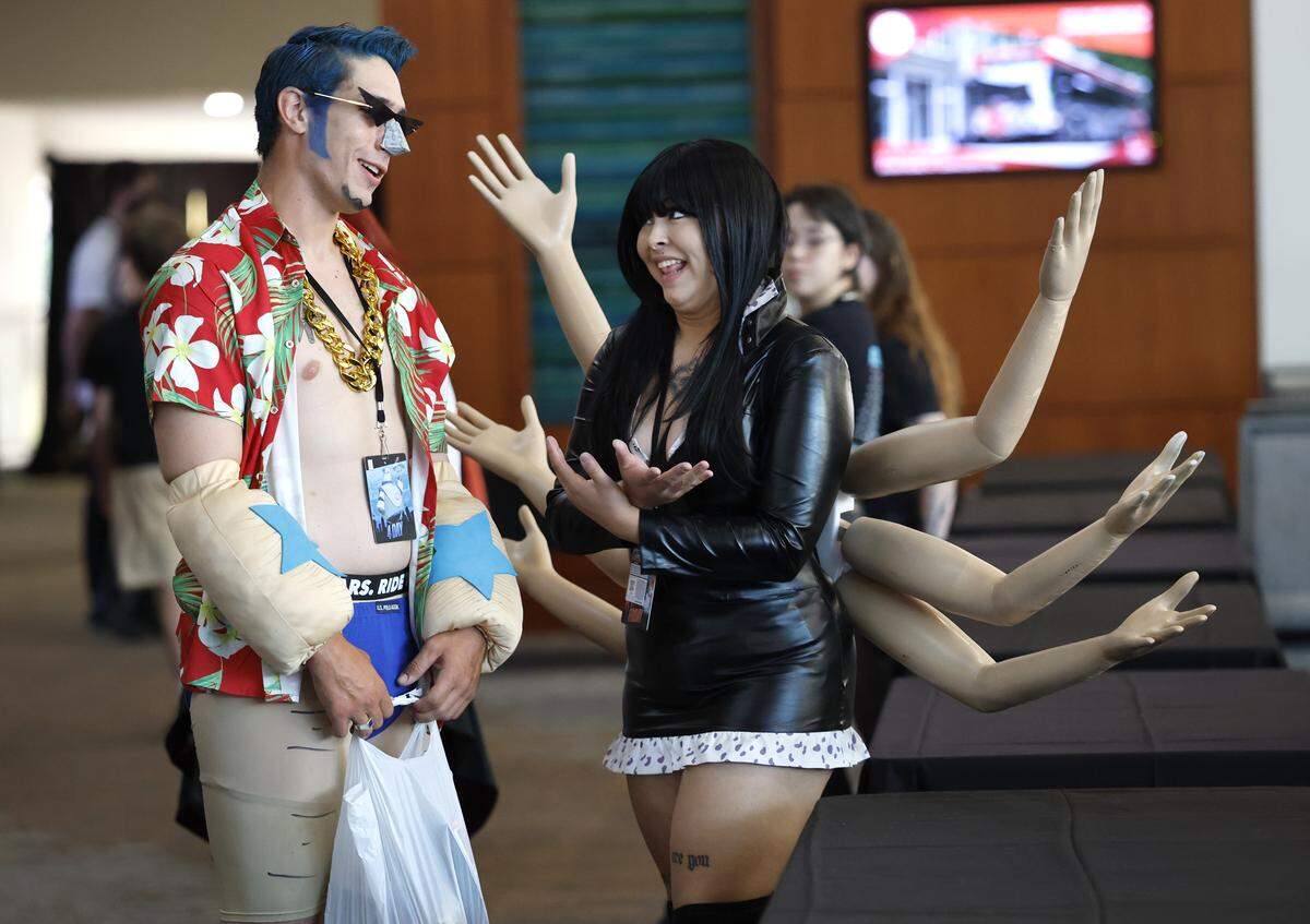 Monika Knecht of Richmond, Va., talks with her boyfriend Jackson Colly during GalaxyCon Raleigh at the Raleigh Convention Center Friday, July 25, 2025. Knecht is cosplaying as Nico Robin and Colly is Franky from One Piece. 