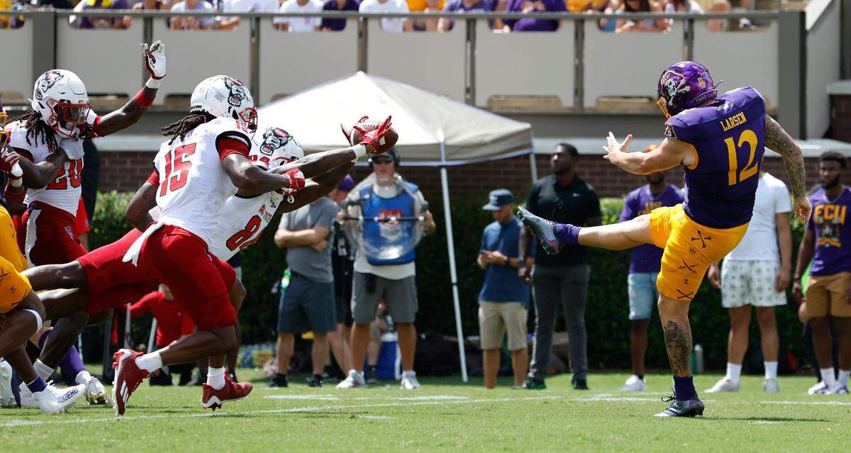 N.C. State’s Jasiah Provillon (84) blocks the punt by East Carolina’s Luke Larsen (12) during the first half of N.C. State’s game against ECU at Dowdy-Ficklen Stadium in Greenville, N.C., Saturday, Sept. 3, 2022.
