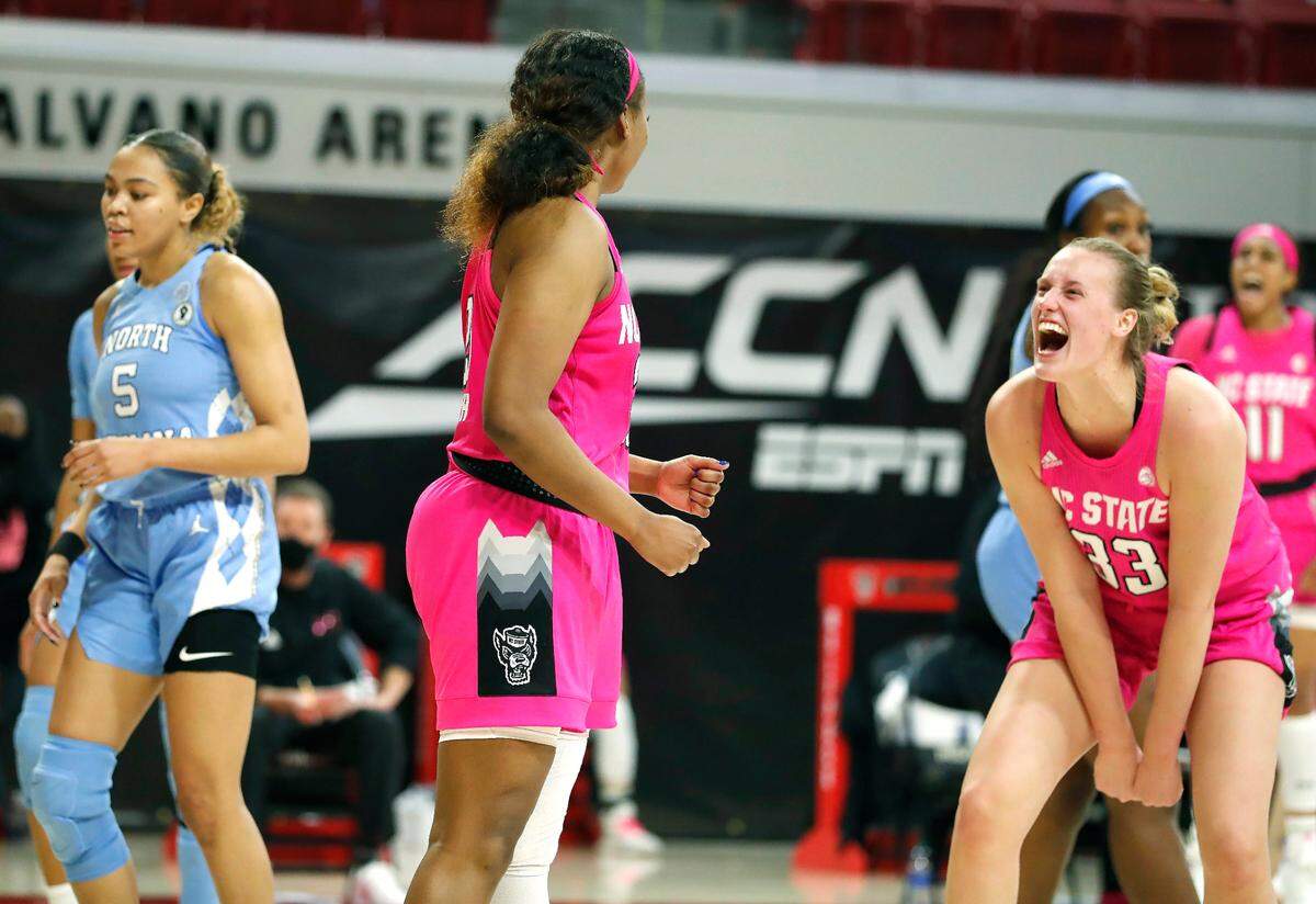 N.C. State’s Elissa Cunane (33) celebrates with Kayla Jones (25) after she made the shot while being fouled during the second half of N.C. State’s 82-63 victory over UNC in the annual Play4Kay game at Reynolds Coliseum in Raleigh, N.C., Sunday, February 21, 2021.