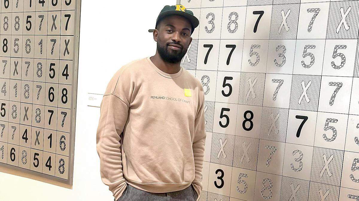 Artist Sherrill Roland stands in front of one of his works on display at the Nasher Museum of Art at Duke University on Oct. 8, 2024.