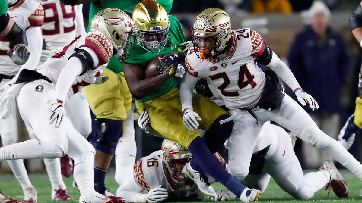 Florida State defensive back Cyrus Fagan (24) tackles Notre Dame’s Jafar Armstrong (8) in the first half of an NCAA college football game in South Bend, Ind.,Saturday, Nov. 10, 2018.