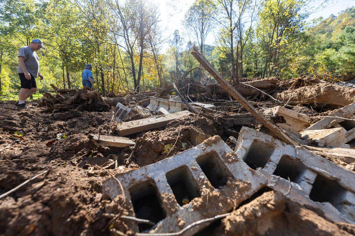 Michael Heatherly, 54, left, and his father Arlen, 81, survey damage caused by a landslide on their family’s property in Cruso. The remnants of Hurricane Helene caused more than 300 landslides, many in North Carolina.