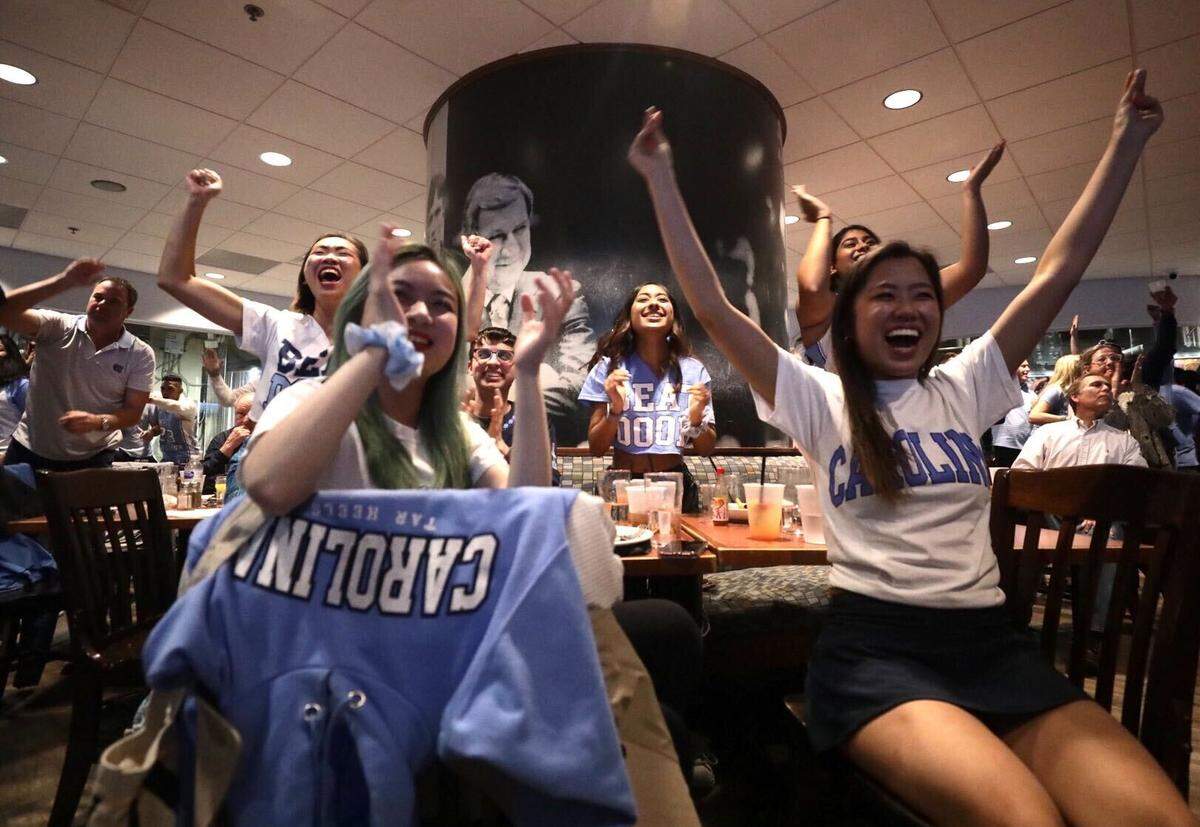 Fans inside Top of the Hill Restaurant and Brewery in Chapel Hill cheer after the Tar Heels score during a tight Final Four game against Duke on Saturday.
