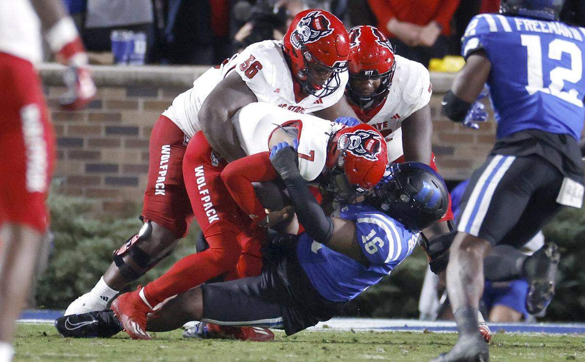 DUPLICATE***N.C. State quarterback MJ Morris (7) is sacked by Duke defensive tackle Aeneas Peebles (16) during the first half of N.C. State’s game against Duke at Wallace Wade Stadium in Durham, N.C., Saturday, Oct. 14, 2023.