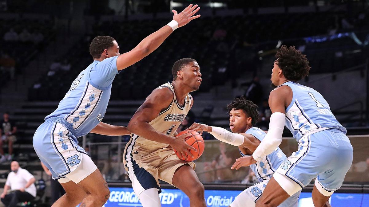 Georgia Tech forward Moses Wright is triple-teamed by North Carolina defenders Garrison Brooks, Caleb Love, and Rechon Black, from left, during the first half of an NCAA college basketball game Wednesday, Dec. 30, 2020, in Atlanta.