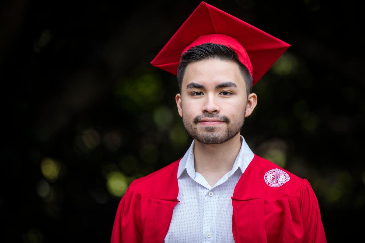 Alex Rojas, 21, stands for a portrait in the cap and gown he wouldÕve worn to his graduation ceremony to celebrate earning his degree in microbiology at N.C. State University, on Wednesday, May 6, 2020, in Raleigh, N.C.