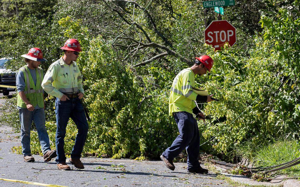 Crews examine downed power lines near the intersection of Englewood Avenue and Clarendon Street on Wednesday, Aug. 16, 2023. following strong storms in Durham, N.C. Tuesday evening.