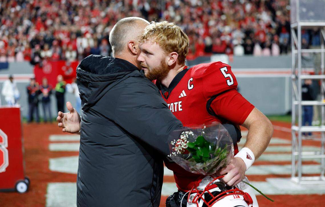 N.C. State head coach Dave Doeren hugs quarterback Brennan Armstrong (5) as Armstrong is recognized before the Wolfpack’s game against UNC at Carter-Finley Stadium in Raleigh, N.C., Saturday, Nov. 25, 2023.
